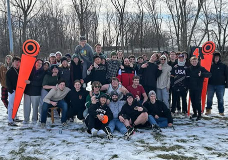 Delta Sigma Phi posing in the snow